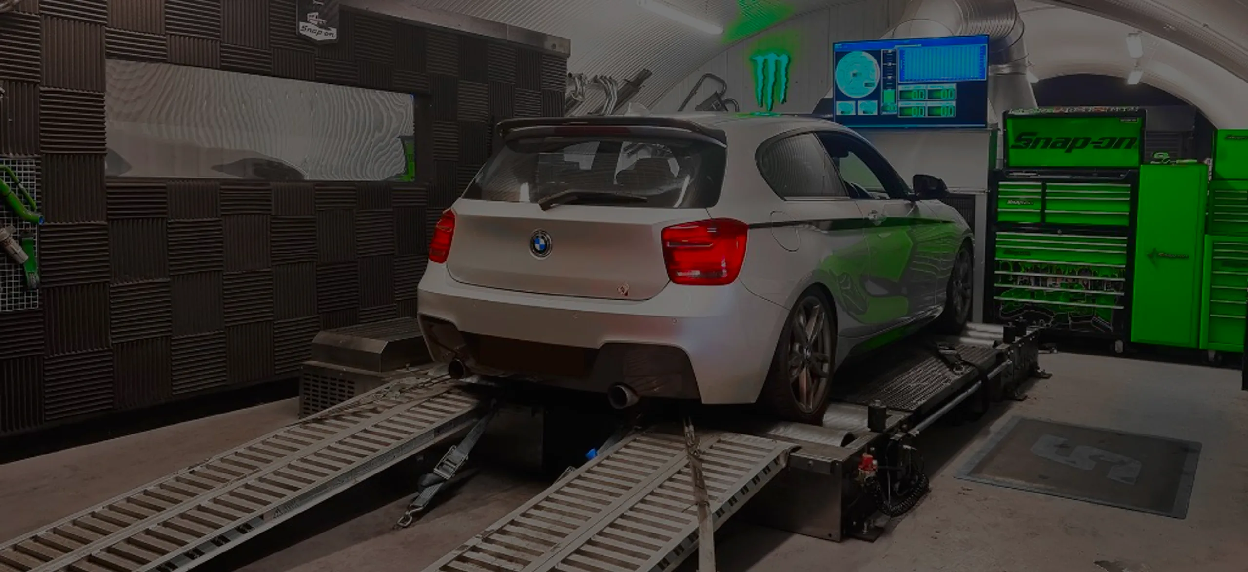 Silver BMW M140i F21 front three-quarter on Dynocom rolling road dyno at 24Tuning Bournemouth Dorset workshop for Stage 1 ECU remapping