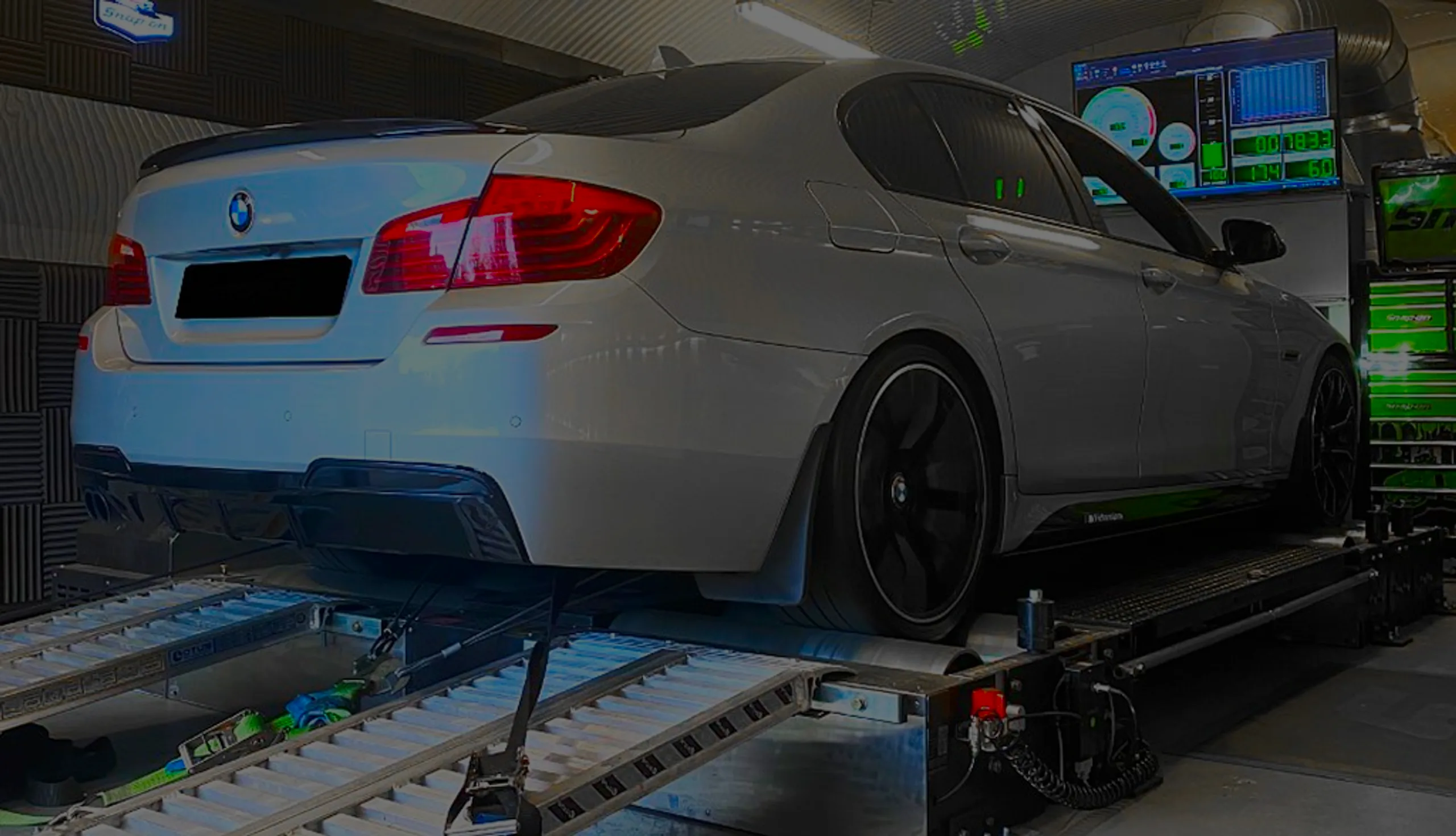 Silver BMW 5 Series F10/F11 rear three-quarter on rolling road dyno at 24Tuning Bournemouth Dorset workshop for Stage 1 ECU remapping