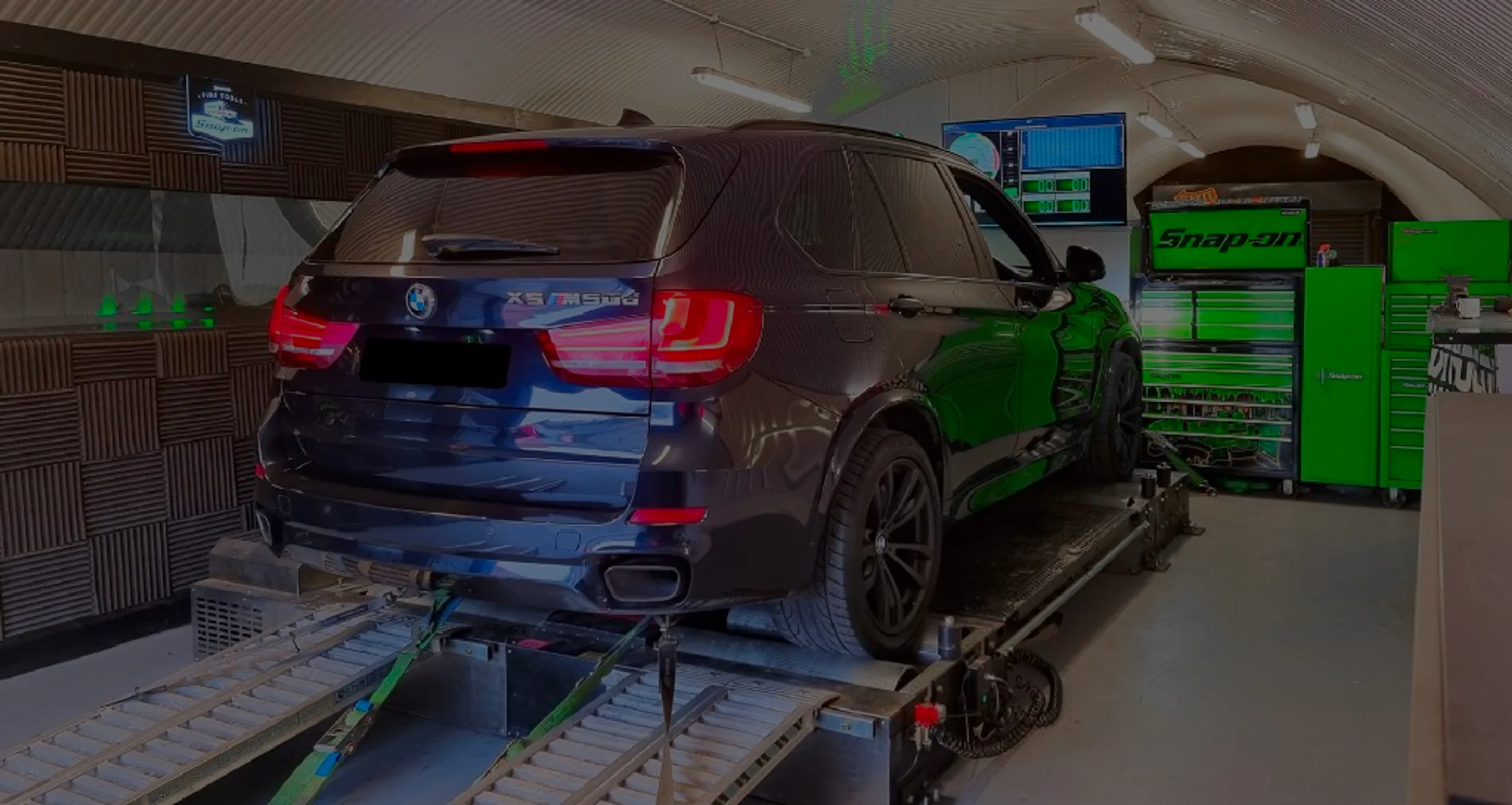 Dark metallic BMW X5 F15 wide panoramic rear on Dynocom rolling road dyno at 24Tuning Bournemouth Dorset workshop for Stage 1 ECU remapping