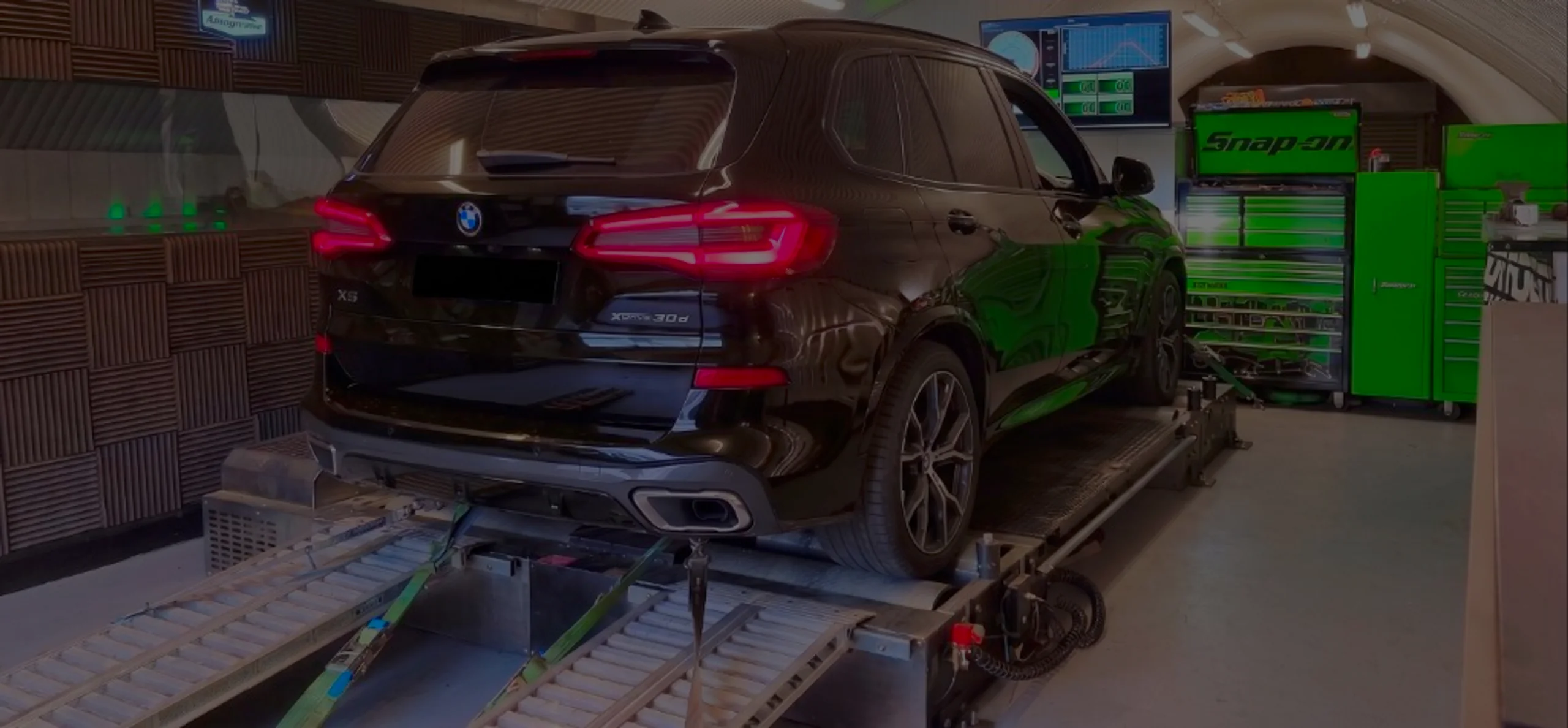 Black BMW X5 xDrive30d G05 wide panoramic rear on Dynocom rolling road dyno at 24Tuning Bournemouth Dorset workshop for Stage 1 diesel ECU remapping