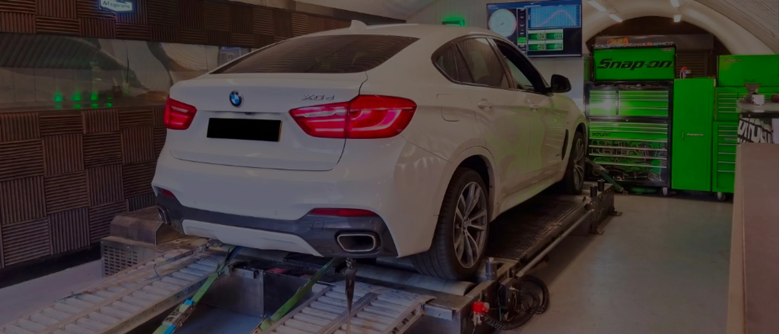 White BMW X6 xDrive30d F16 wide panoramic rear on Dynocom rolling road dyno at 24Tuning Bournemouth Dorset workshop for Stage 1 diesel ECU remapping