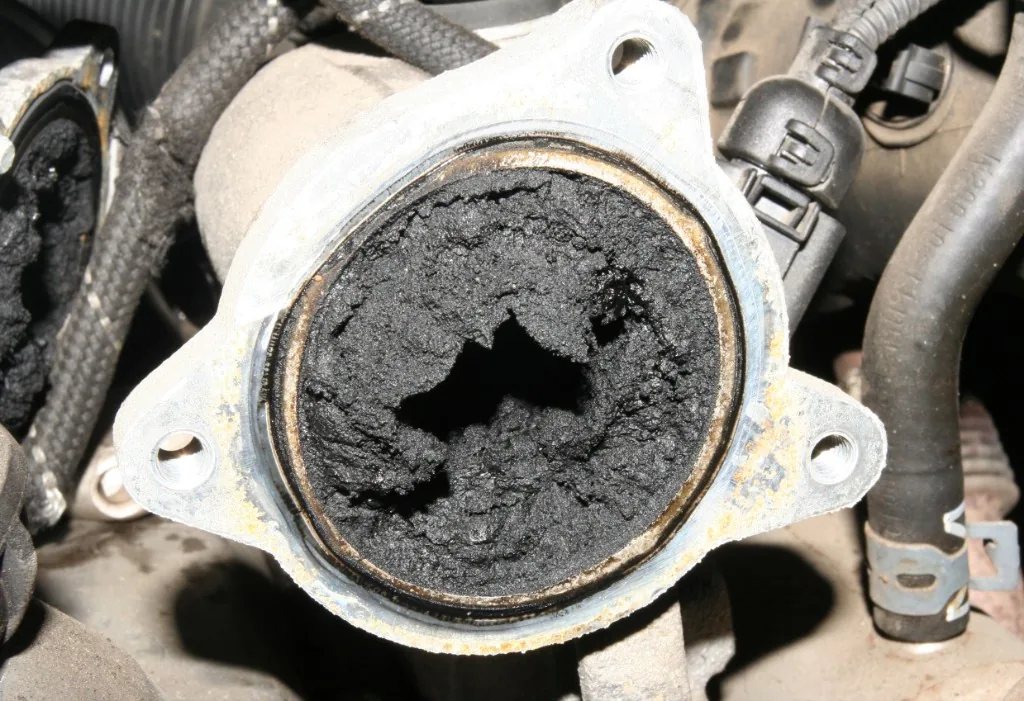 Severely clogged EGR valve almost blocked by thick carbon soot — EGR repair Bournemouth Dorset