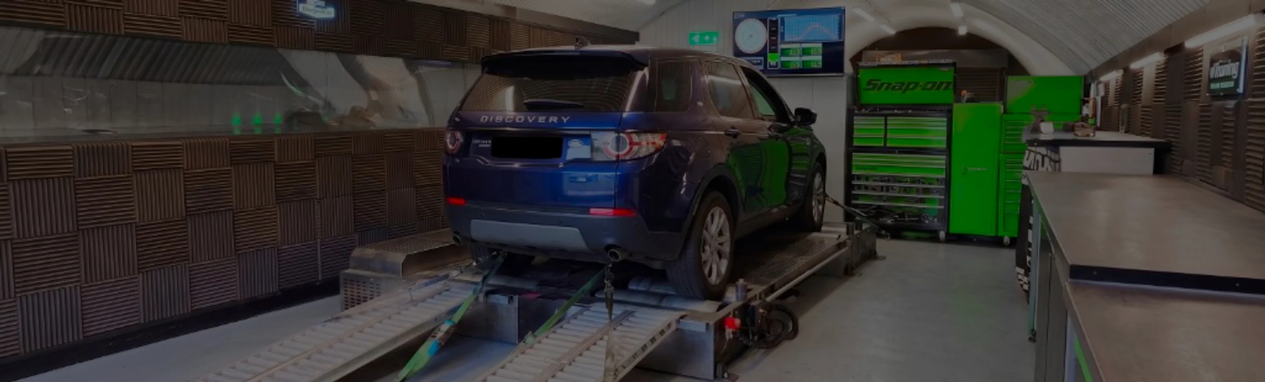 Dark blue Land Rover Discovery Sport L550 wide panoramic rear on Dynocom rolling road dyno at 24Tuning Bournemouth Dorset workshop for Stage 1 diesel ECU remapping