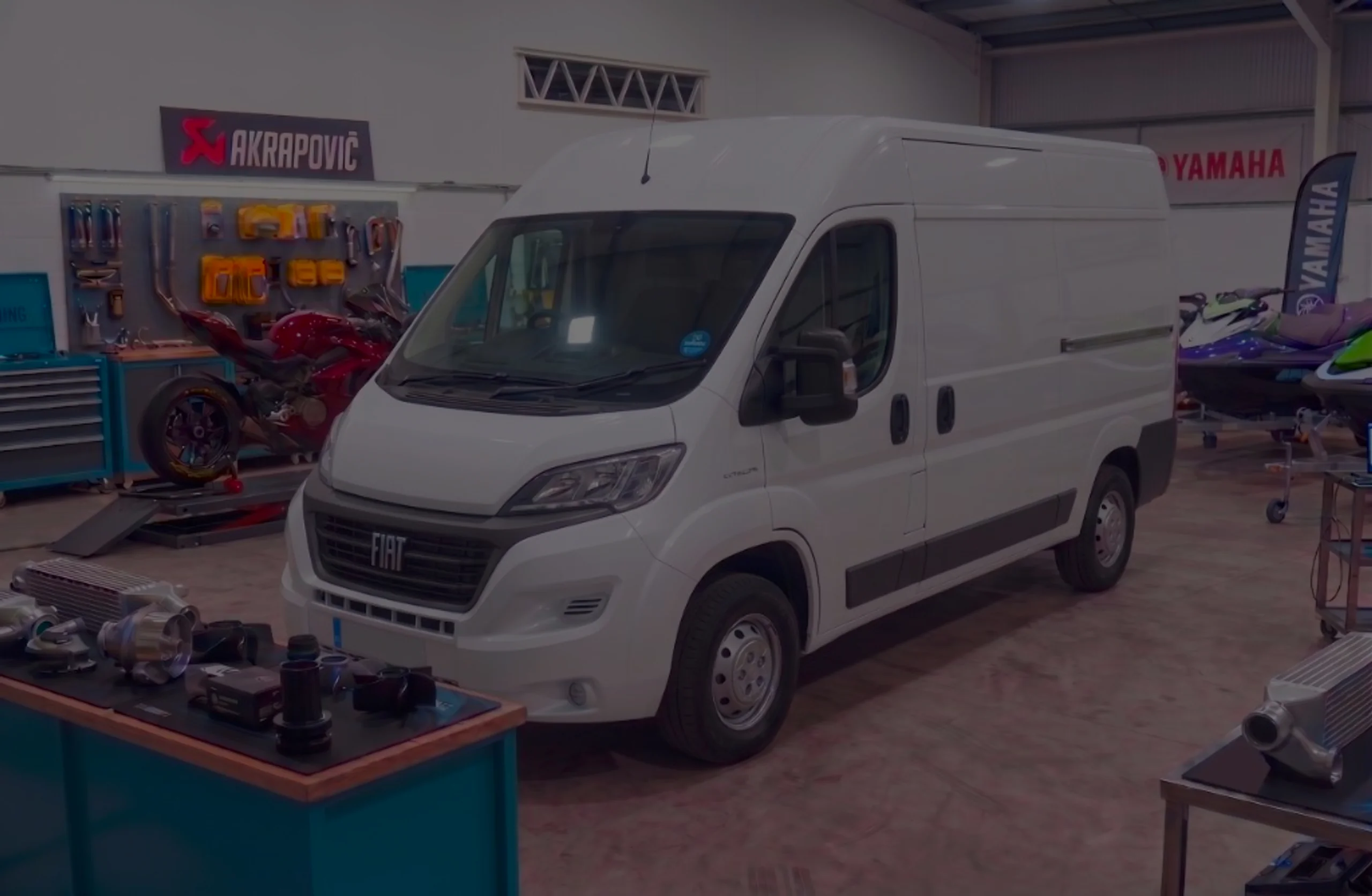 White Fiat Ducato front three-quarter in 24Tuning Bournemouth Dorset workshop with Fiat badge for Stage 1 ECU remapping