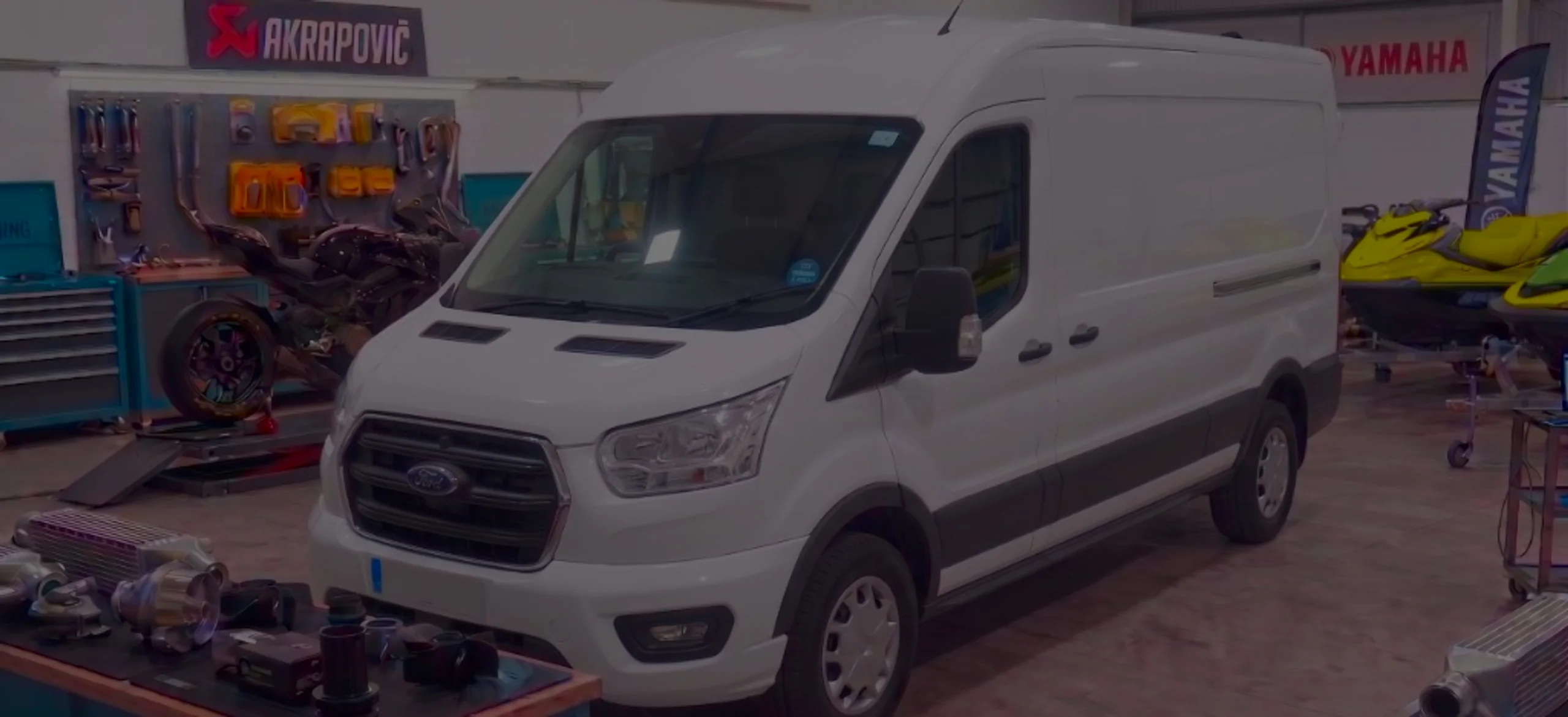 White Ford Transit front three-quarter in 24Tuning Bournemouth Dorset workshop with Ford badge for Stage 1 ECU remapping