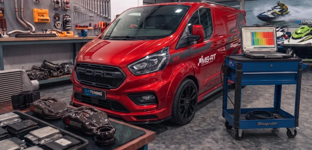 Transit Custom Remap Workshop | 24Tuning Red Ford Transit Custom MS-RT in the 24Tuning workshop with remapping laptop connected — Bournemouth Dorset
