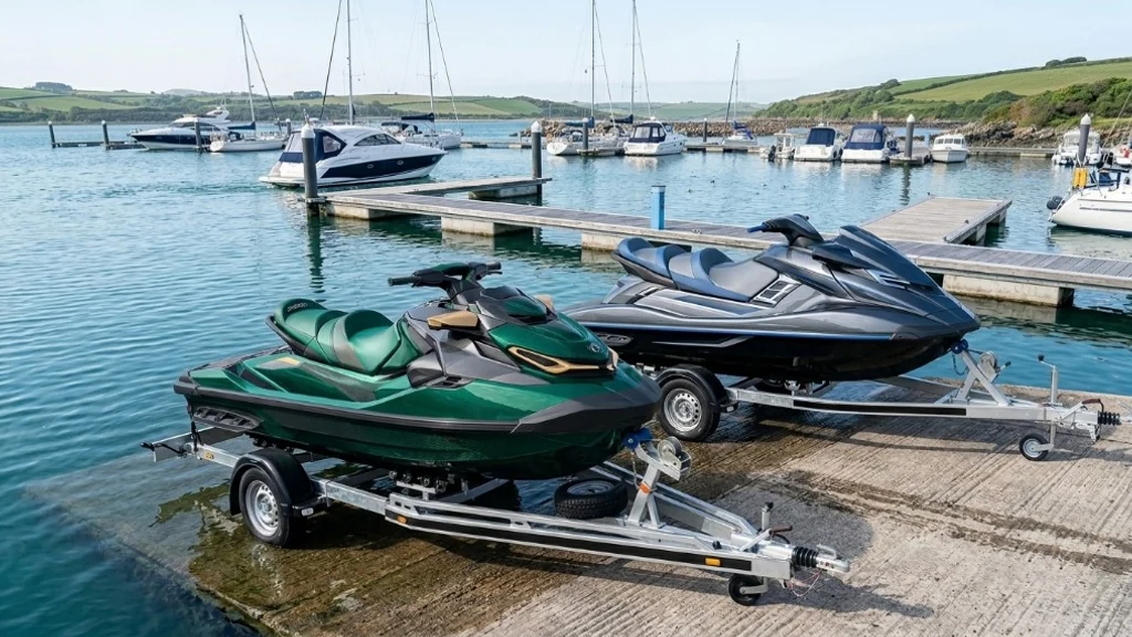 Emerald green and charcoal jet skis on trailers at a marina slipway - jet-ski diagnostics by 24Tuning Bournemouth Dorset
