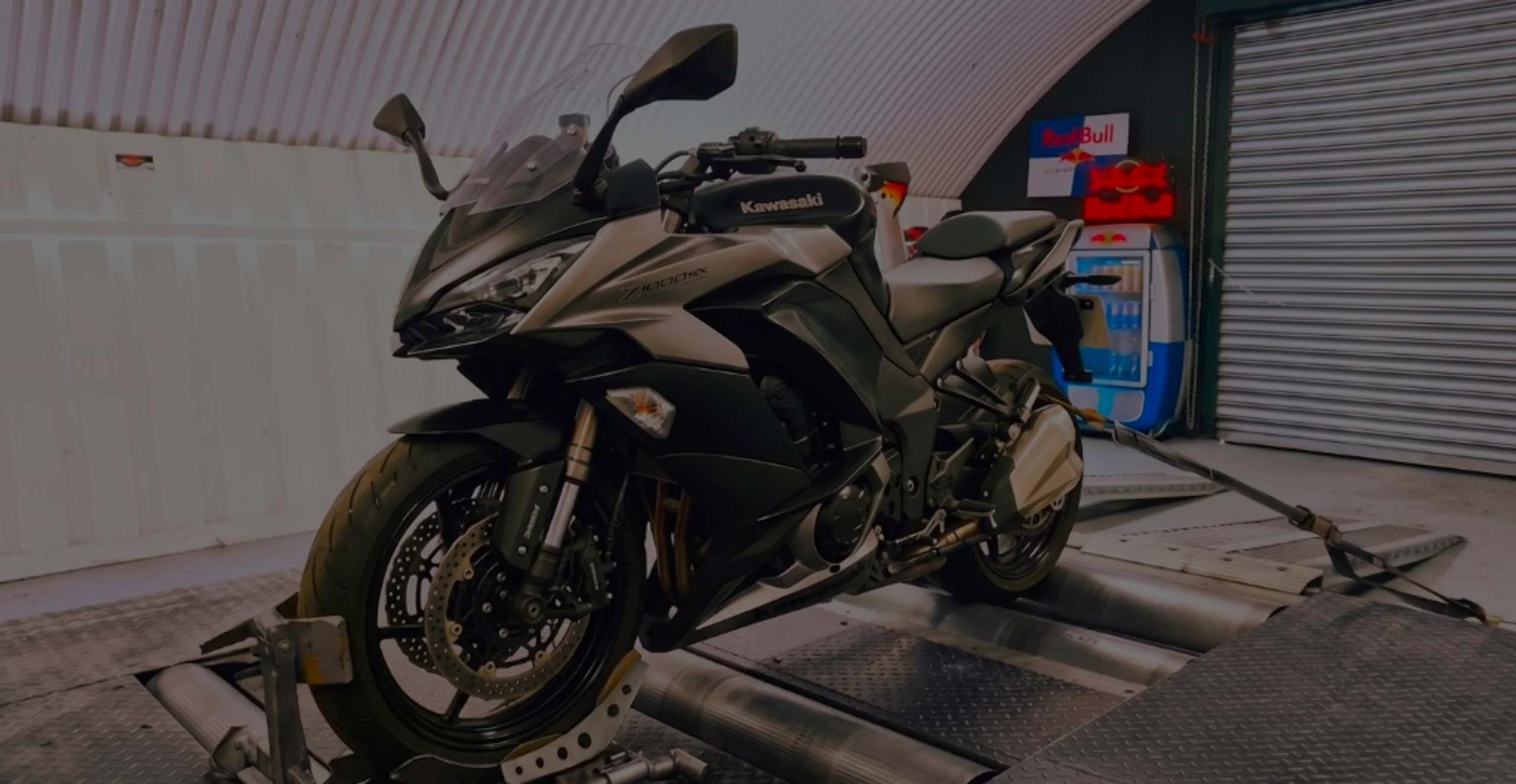 Silver and black Kawasaki Z1000 SX front three-quarter on motorcycle rolling road dyno with Z1000 SX fairing lettering at 24Tuning Bournemouth Dorset workshop for Stage 1 ECU remapping