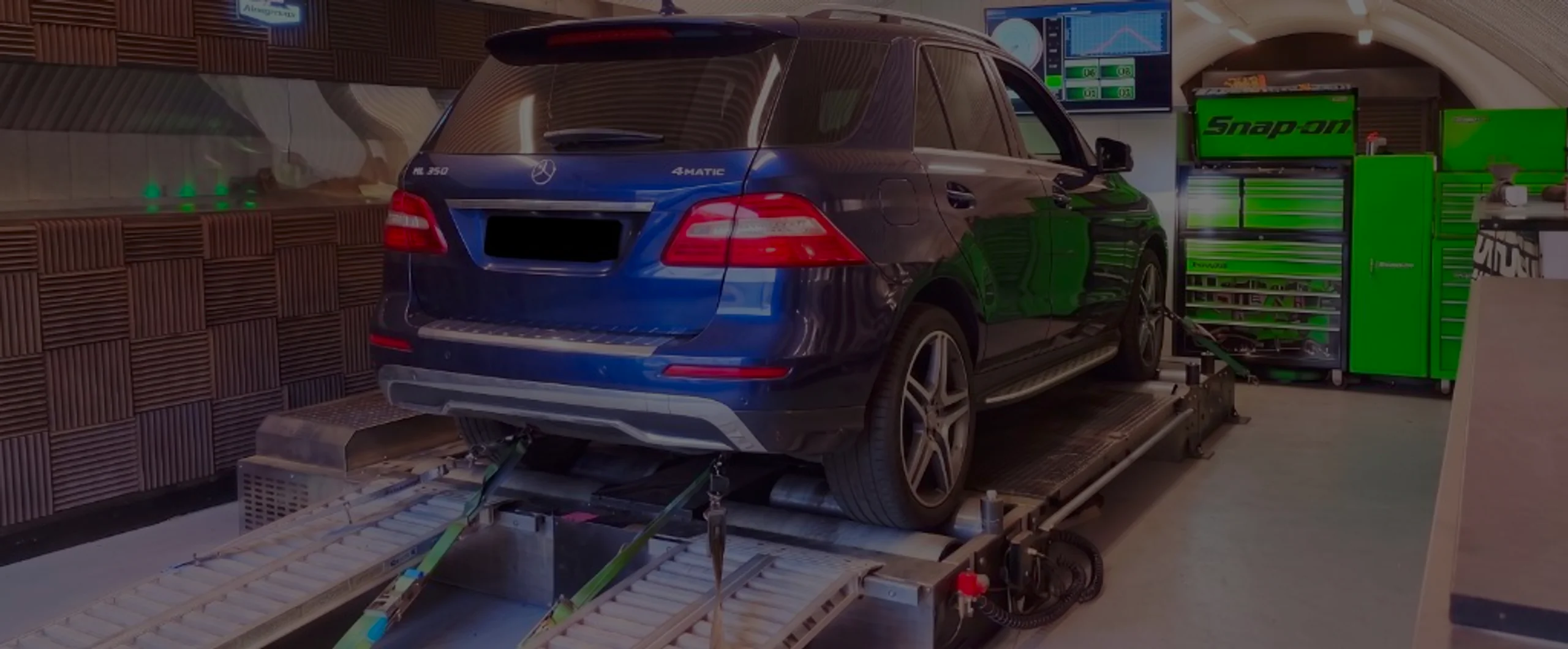 Dark blue Mercedes ML 350 4MATIC W166 wide panoramic rear on Dynocom rolling road dyno at 24Tuning Bournemouth Dorset workshop for Stage 1 diesel ECU remapping