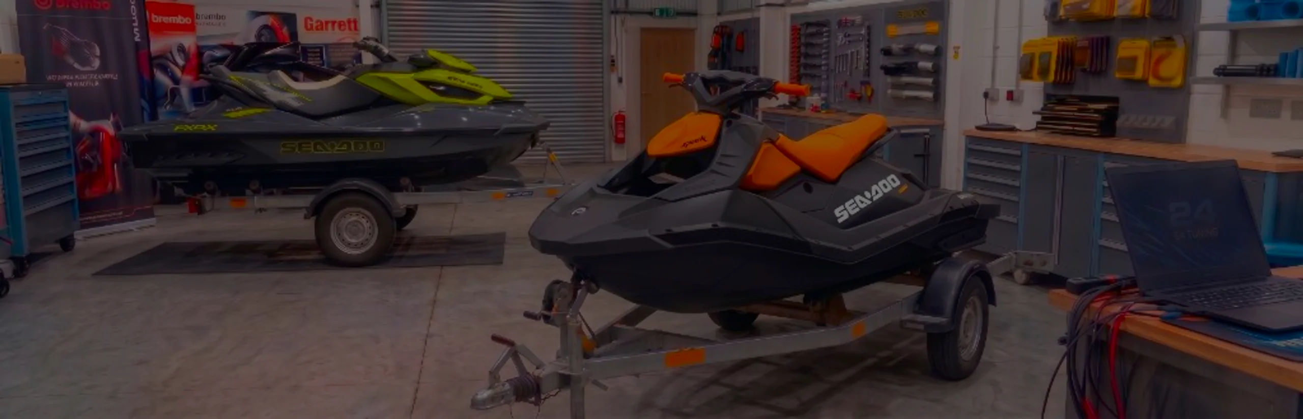 Sea-Doo Spark 900 Remap Bournemouth Poole Dorset | 24Tuning Black and orange Sea-Doo Spark jet ski on a trailer in the 24Tuning Bournemouth Dorset workshop with ECU remapping laptop and tuning cables for Stage 1 PWC calibration