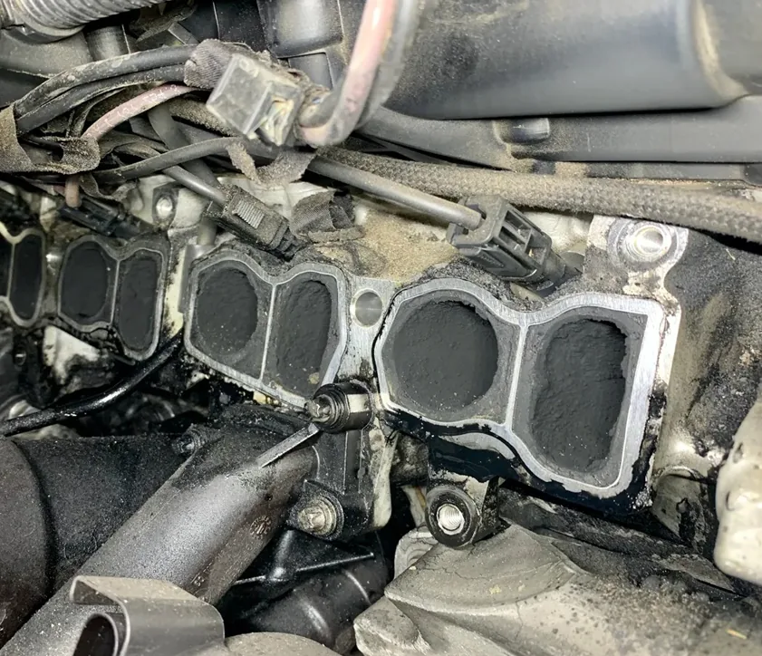 Carbon Intake Ports | 24Tuning Cylinder head intake ports heavily clogged with carbon soot after manifold removal — Bournemouth Dorset