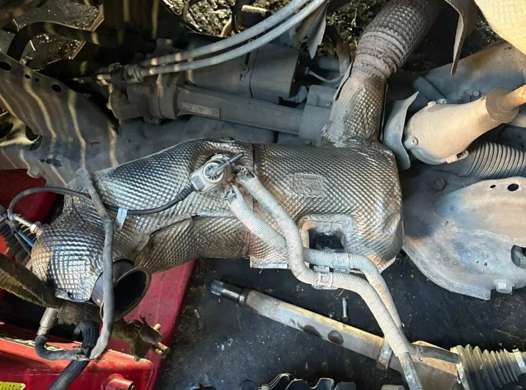 Diesel particulate filter assembly with heat shield and sensors removed during van DPF work — Bournemouth Dorset