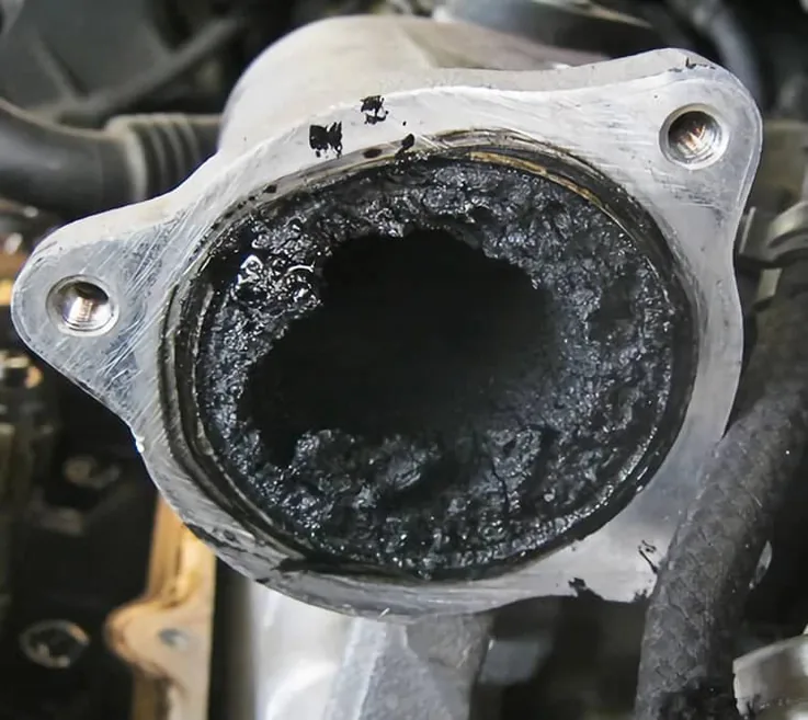 Blocked van EGR intake pipe almost closed by thick carbon soot — Bournemouth Dorset