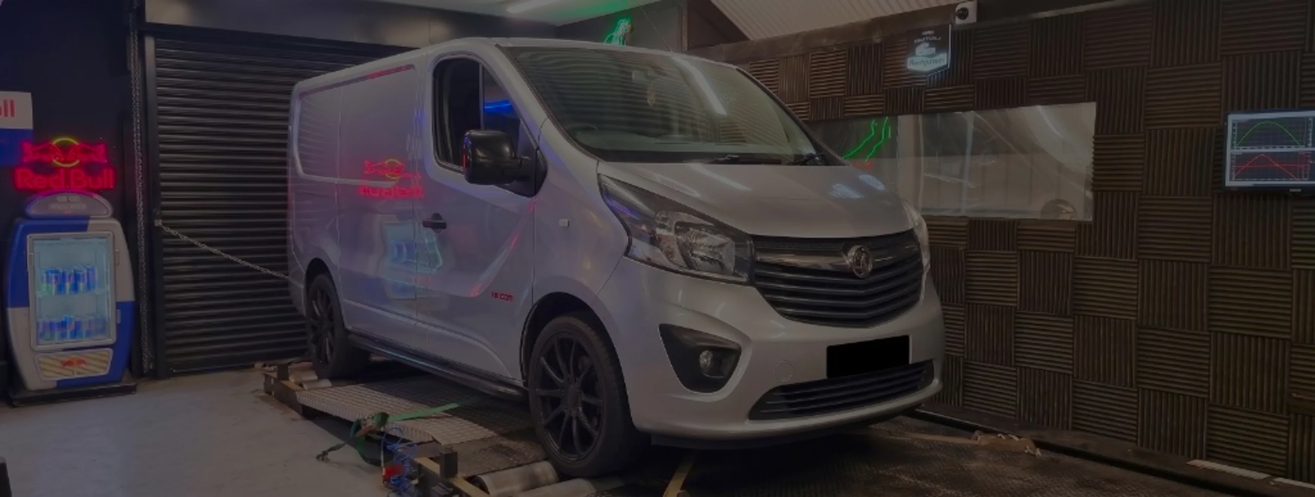 Silver Vauxhall Vivaro front three-quarter on rolling road dyno with 1.6 CDTi badge and green safety strap at 24Tuning Bournemouth Dorset workshop for Stage 1 ECU remapping