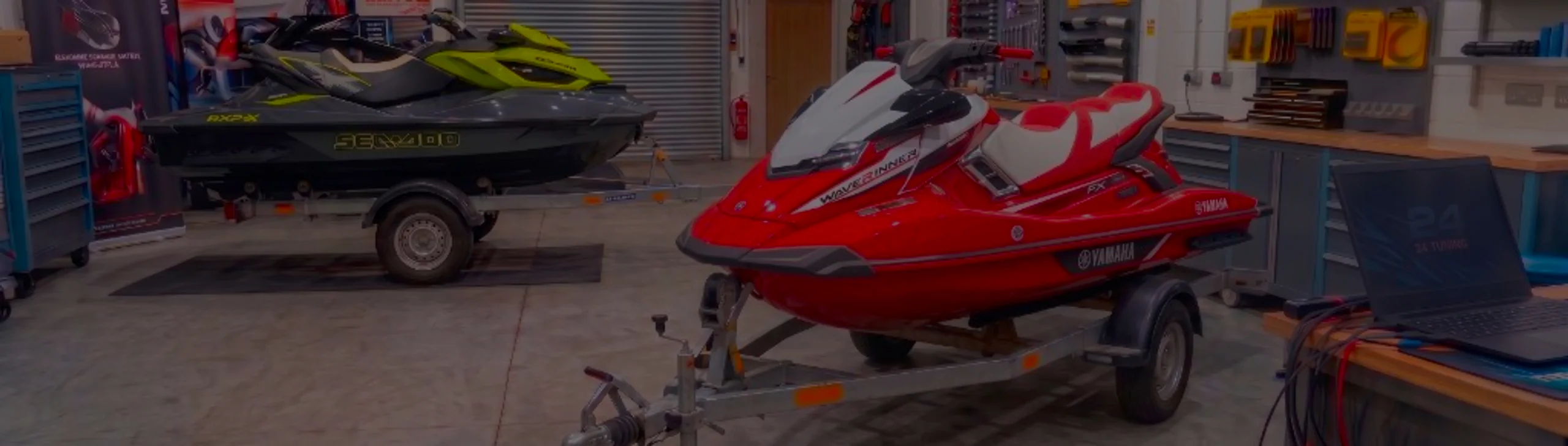 Red white and black Yamaha FX SVHO WaveRunner on a trailer in the 24Tuning Bournemouth Dorset workshop with ECU remapping laptop and tuning cables for Stage 1 PWC calibration