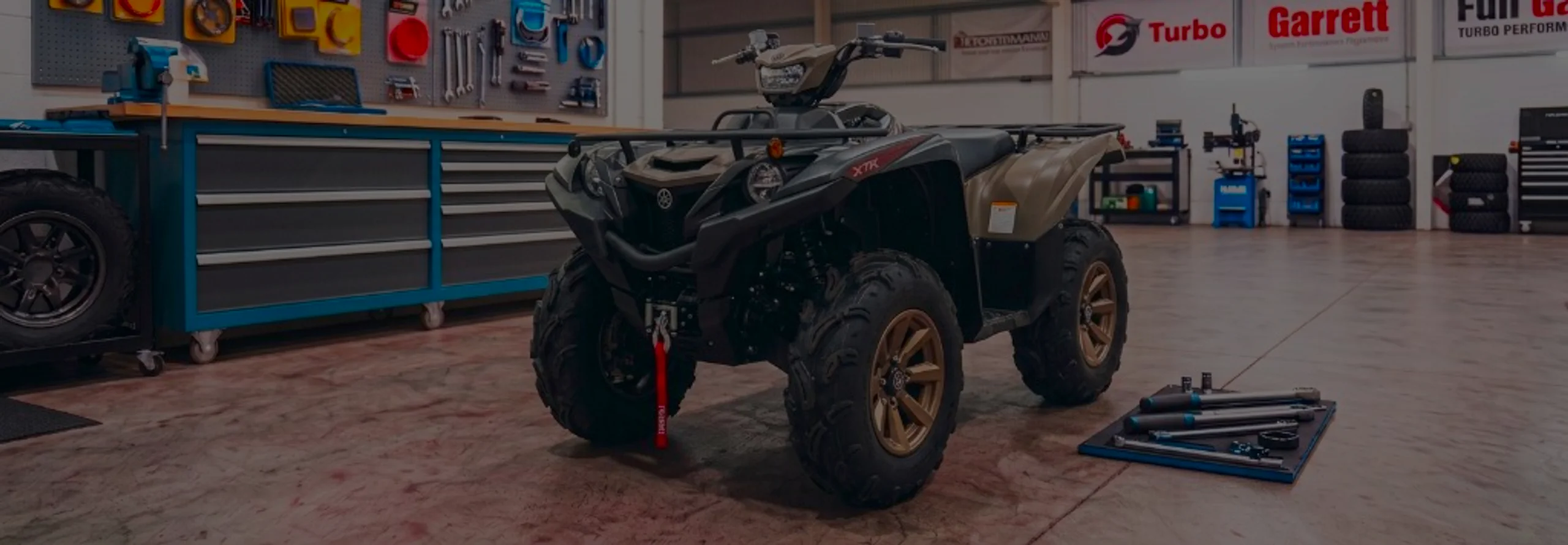 Yamaha Grizzly 700 Remap Bournemouth Poole Dorset | 24Tuning Tan Yamaha Grizzly 700 XTR in 24Tuning Bournemouth Dorset workshop with tool chest, Garrett turbo banner and torque wrenches for Stage 1 ECU remapping