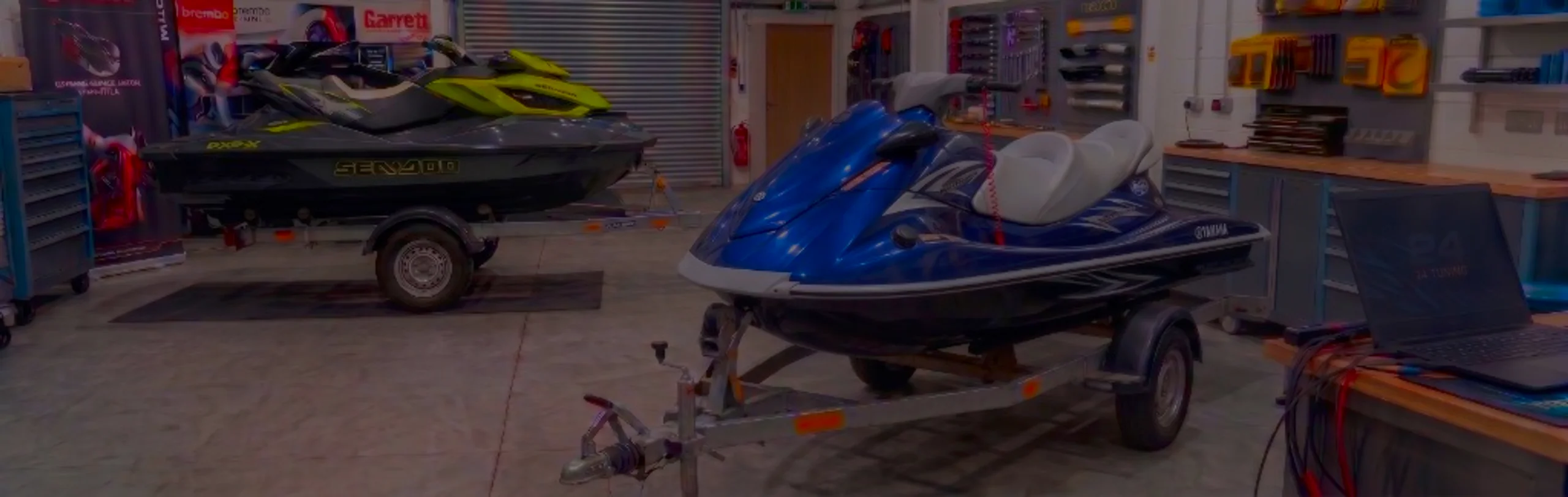 Dark blue Yamaha VX Sport WaveRunner on a trailer in the 24Tuning Bournemouth Dorset workshop with ECU remapping laptop and tuning cables for Stage 1 PWC calibration